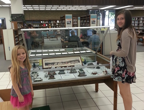 Caitlin and Maddy setting up the display at the Clifton M. Brakensiek Library of Bellflower